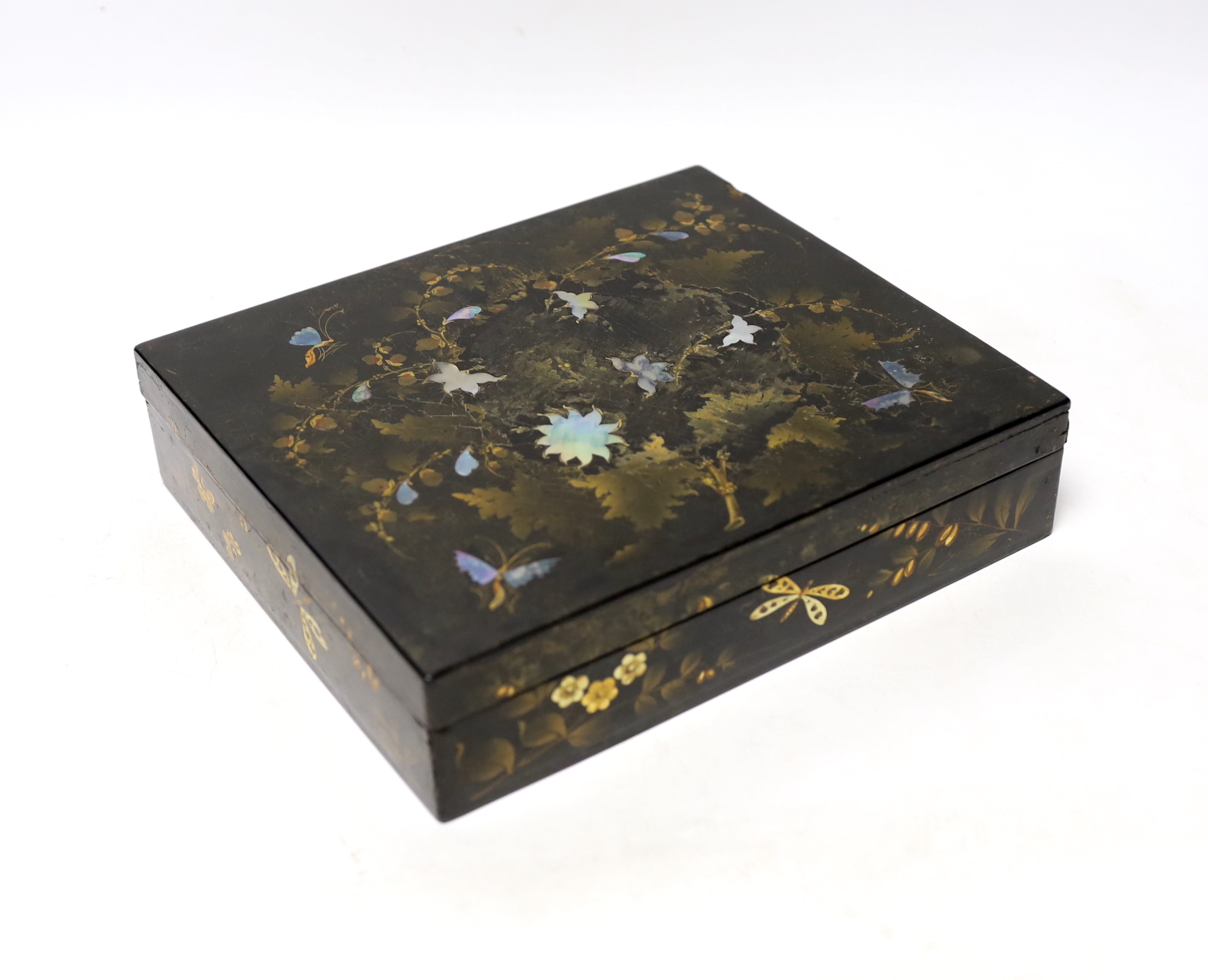 A 19th century lacquer games box with sectional interior and a collection of 49 mother of pearl gaming counters, some armorial, 22 x 19 x 5cm
